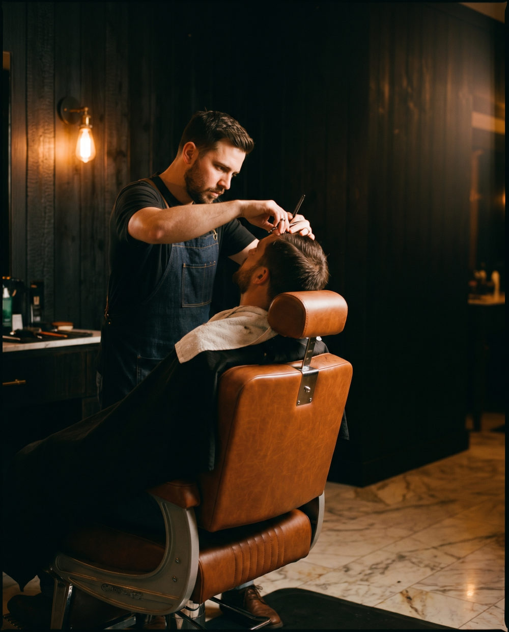 A barber at work at Black Pine, Fate TX